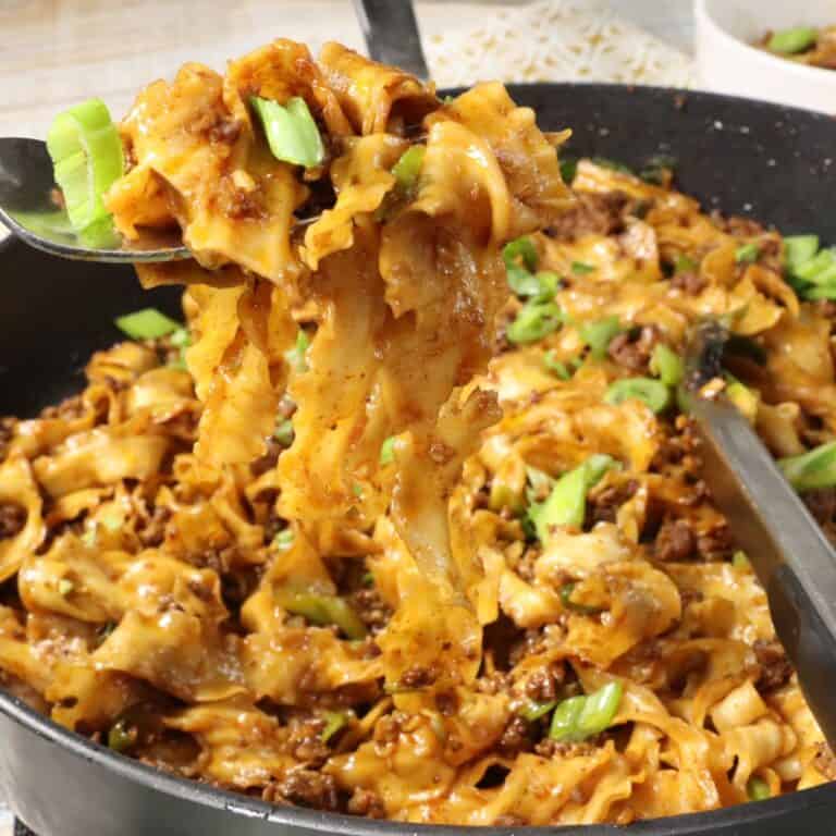 a forkful of spicy garlic chili noodles right out of the pan