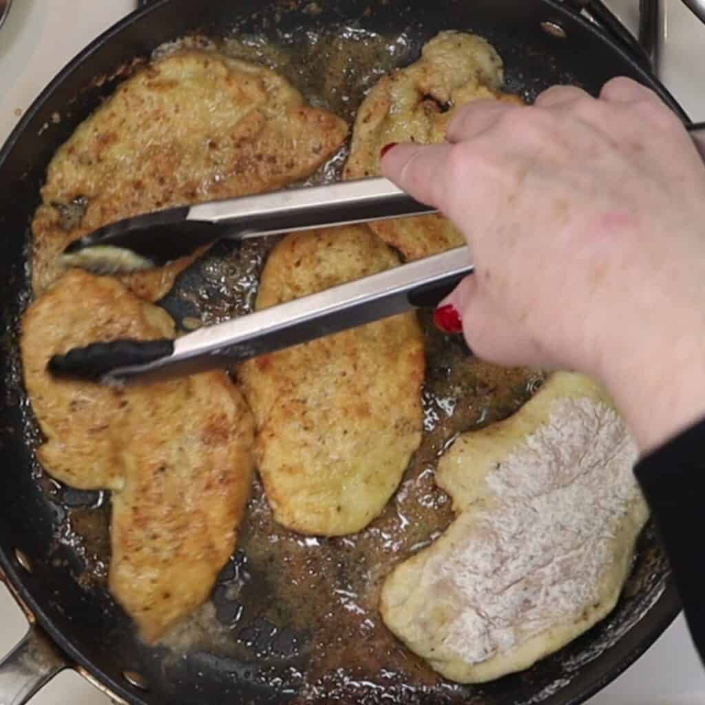 browning the chicken in a pan with olive oil and butter