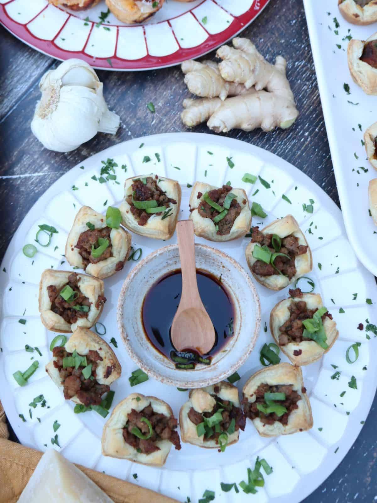 overhead view of soy ginger pork puffs garnished with scallions ans cilantro