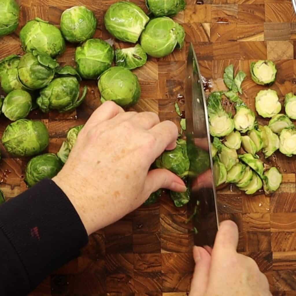 cutting the ends off the brussels sprouts for roasted brussels sprouts and radicchio with maple mustard drizzle