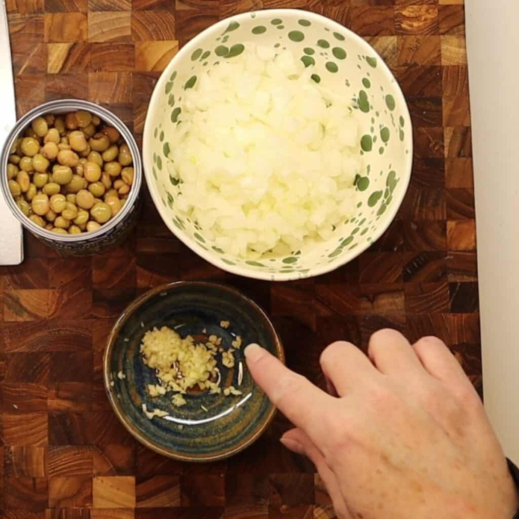 dice onion, garlic and open pigeon peas