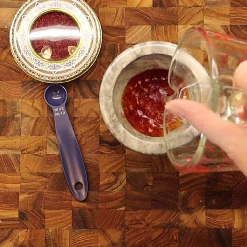 adding water to ground saffron to make saffron water