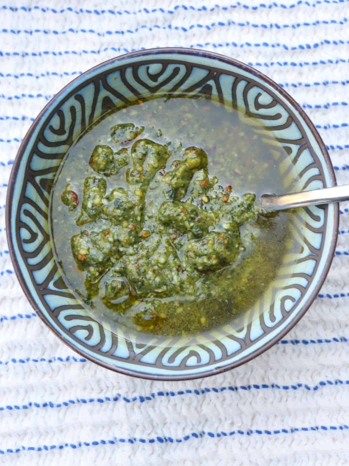 bowl of pistachio pesto on a towel