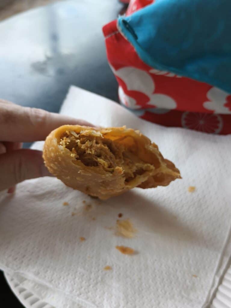 gobbling up my chicken empanada in puerto rico