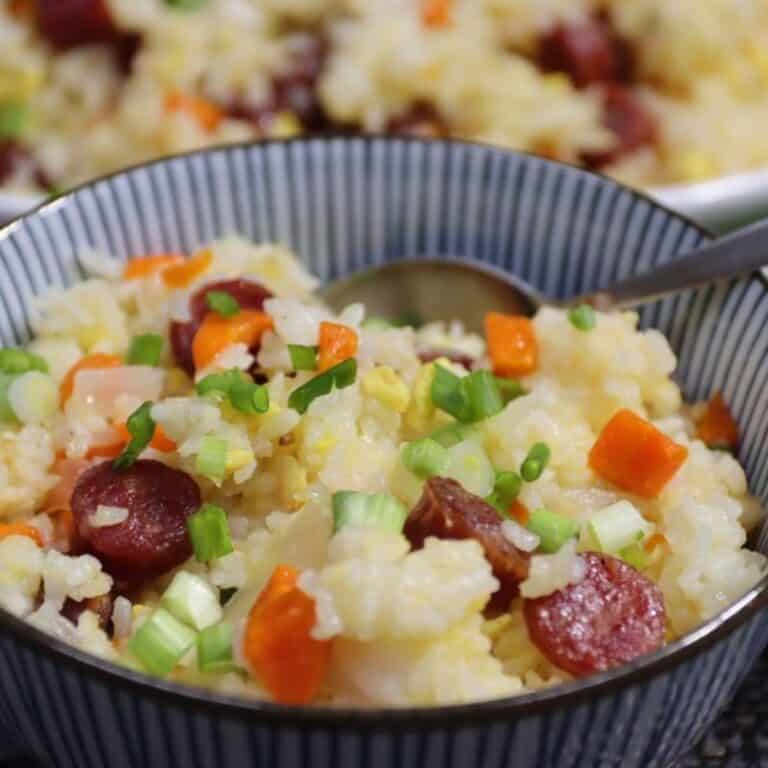 fried rice with chinese sausage in a bowl with scallion garnish